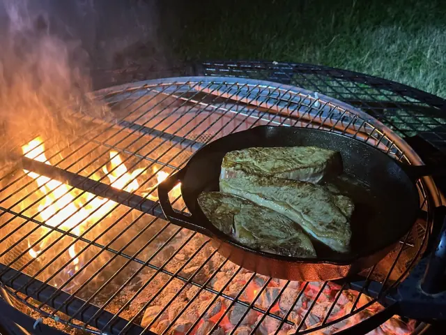 Steaks in cast iron over the fire